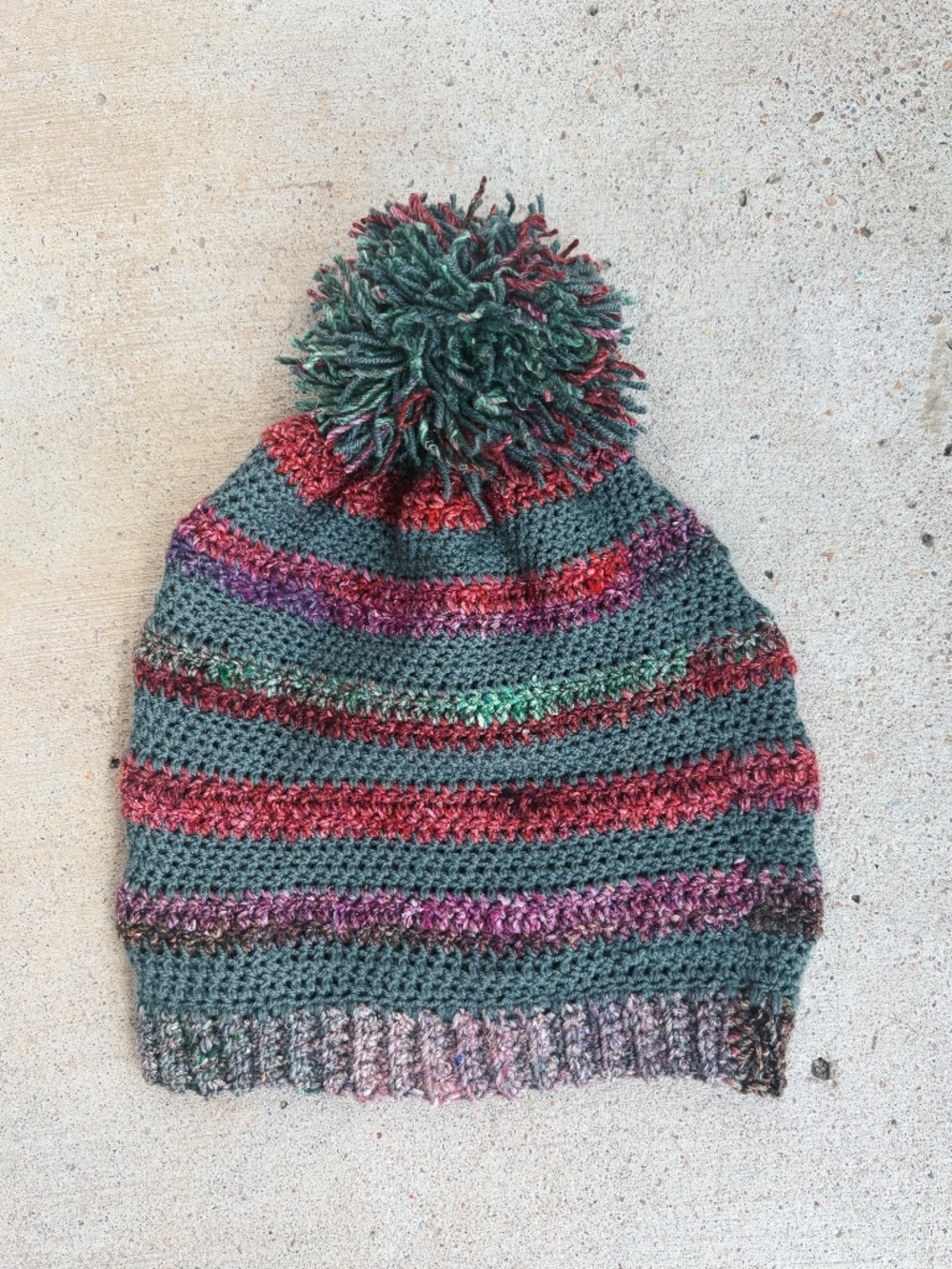 Handmade Crocheted Pom Pom Hat in Green with Colorful Stripes